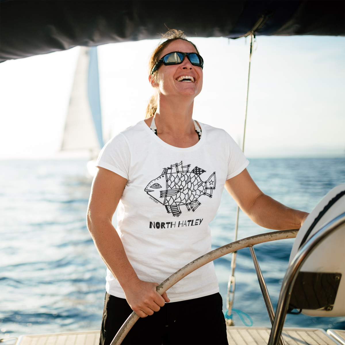https://www.marcsamsonartist.com/wp-content/gallery/north-hatley/t-shirt-mockup-featuring-a-smiling-woman-on-a-fishing-boat-40630-r-el2.png